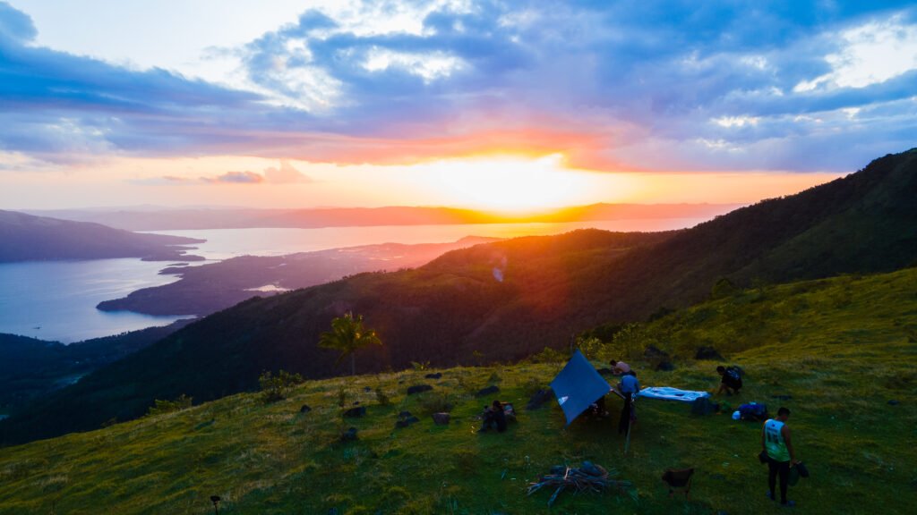 Overnight camping in the mountains of Biliran with a stunning sunset view over the sea and hills.
