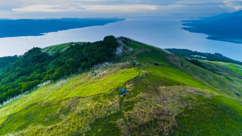 Scenic viewpoint in Biliran, Philippines, with rolling green hills and ocean views, part of authentic travel activities.