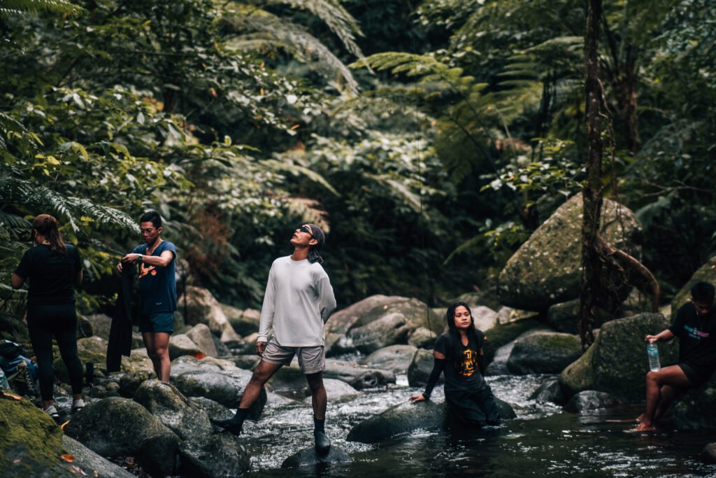 Group of travelers exploring a tropical forest river in Biliran, Philippines.