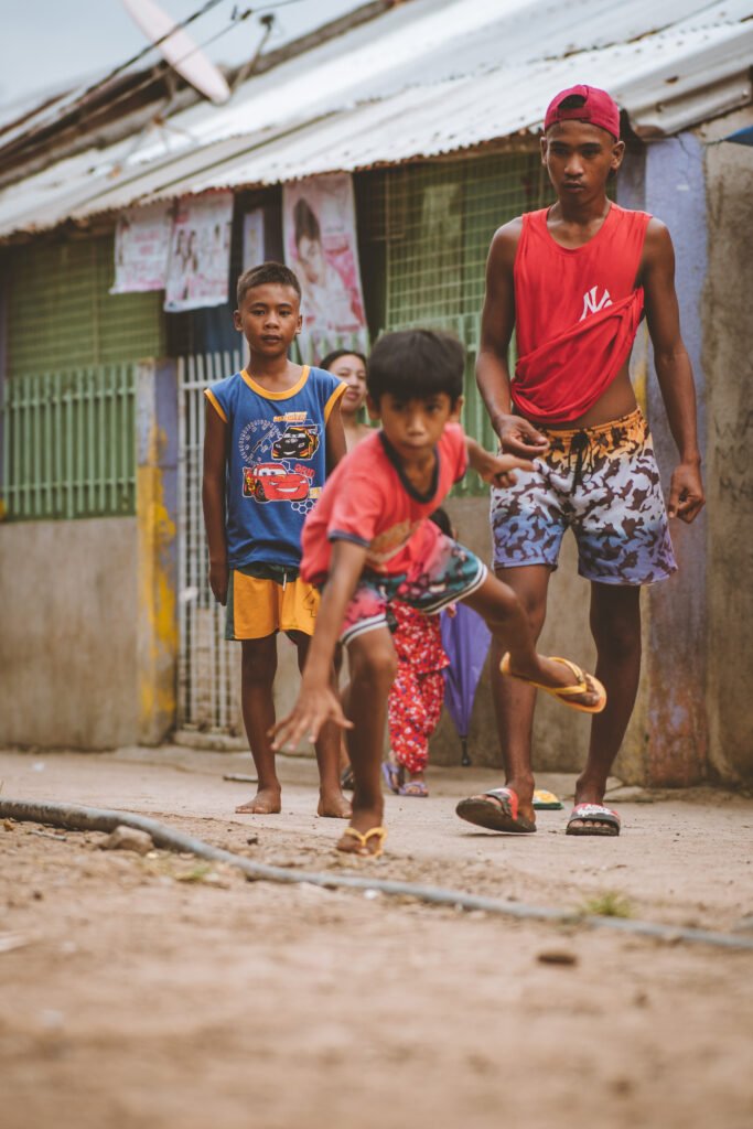 Children playing traditional street games in a Filipino village during an everyday immersion experience.