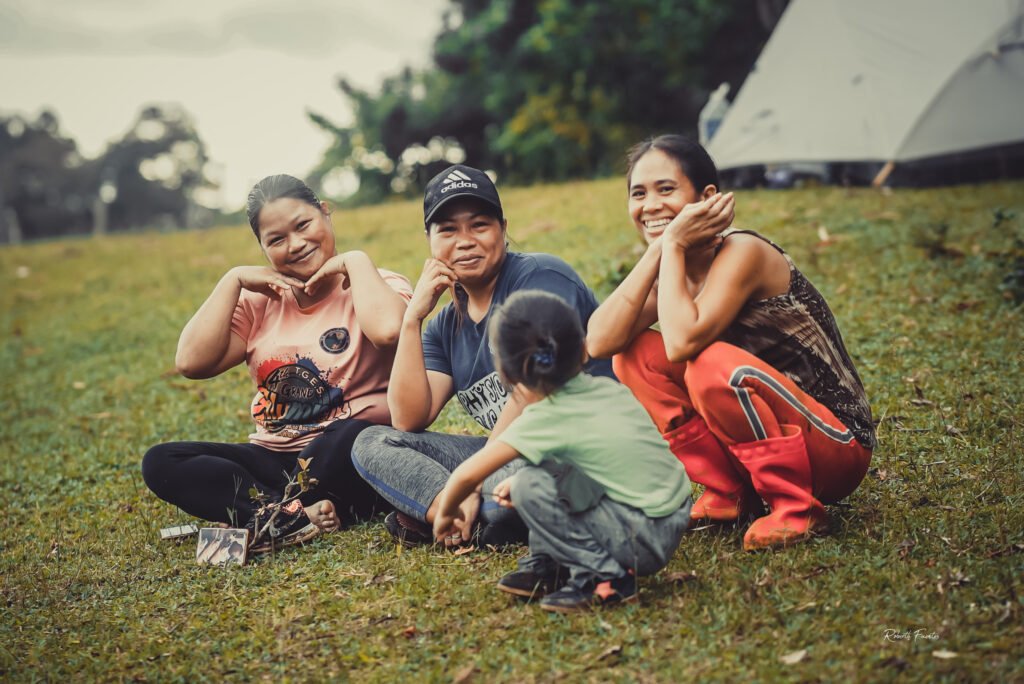 Host family in Biliran sharing laughter with travelers during an authentic homestay immersion in the Philippines.