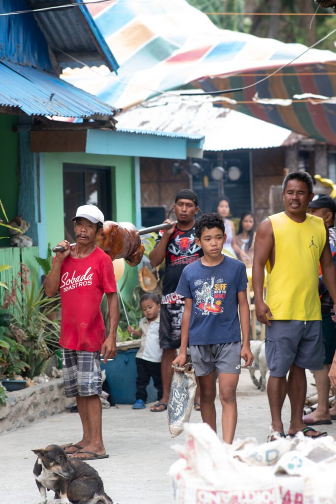 Villagers carrying Lechon Baboy during a traditional Filipino feast in Biliran.