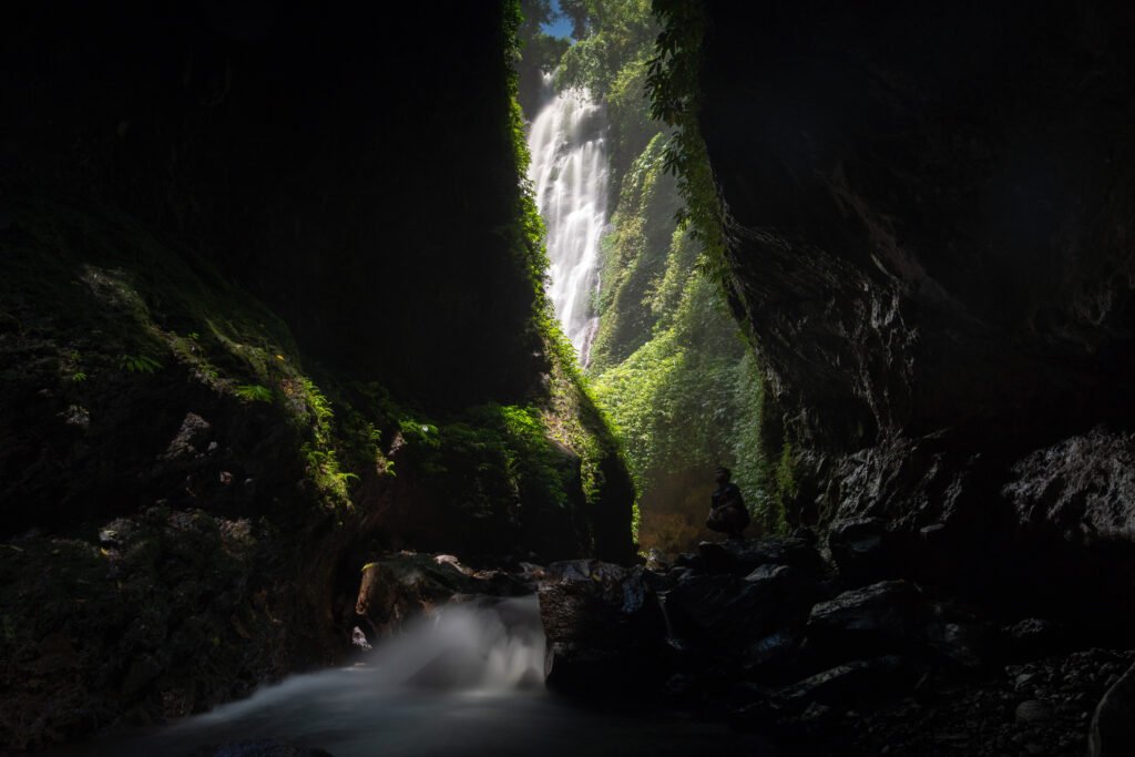 Waterfall in Biliran, Philippines, surrounded by tropical cliffs and lush greenery.