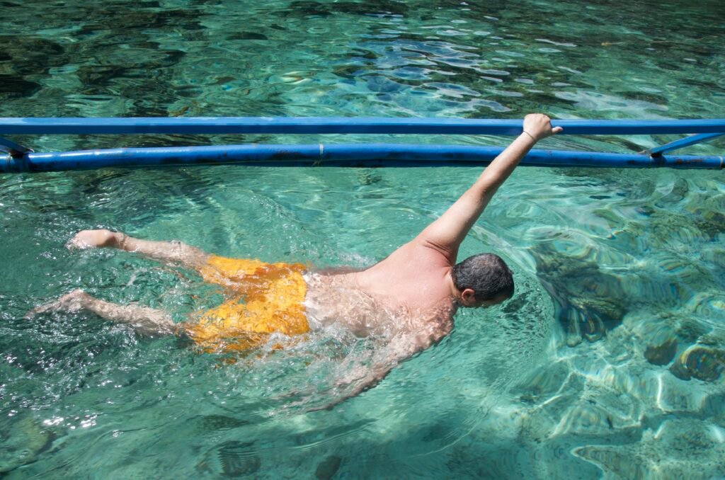 Traveler snorkeling in the clear turquoise waters of Dalutan Island, Philippines.