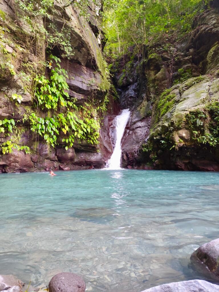 Hidden waterfall in Biliran with turquoise natural pool surrounded by tropical forest.