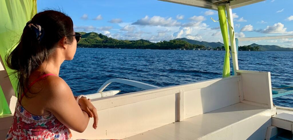 Traveler on a traditional bangka boat in Biliran, enjoying authentic island immersion in the Philippines.