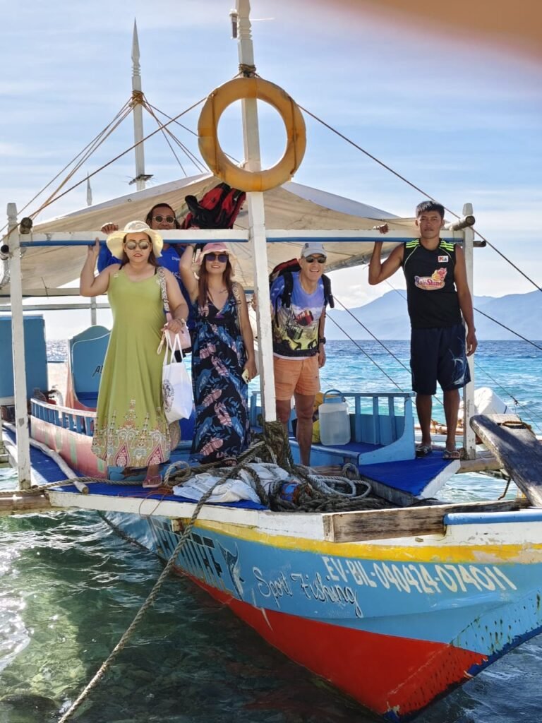 Travelers arriving at Sambawan Island on a traditional bangka boat, Biliran, Philippines.