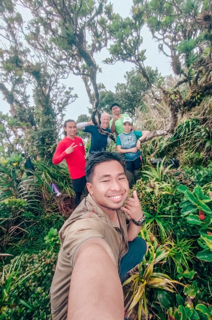 Travelers hiking in the Tres Marias mountains, Biliran, Philippines, surrounded by lush tropical forest.