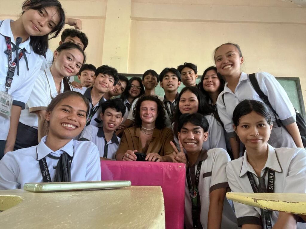Traveler sharing a moment with local students in a classroom during an everyday immersion in Biliran, Philippines.